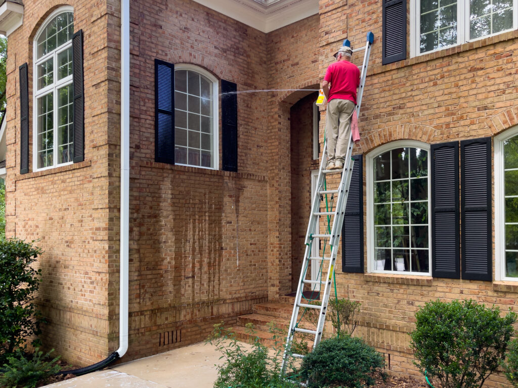 professional window cleaning service on brick home